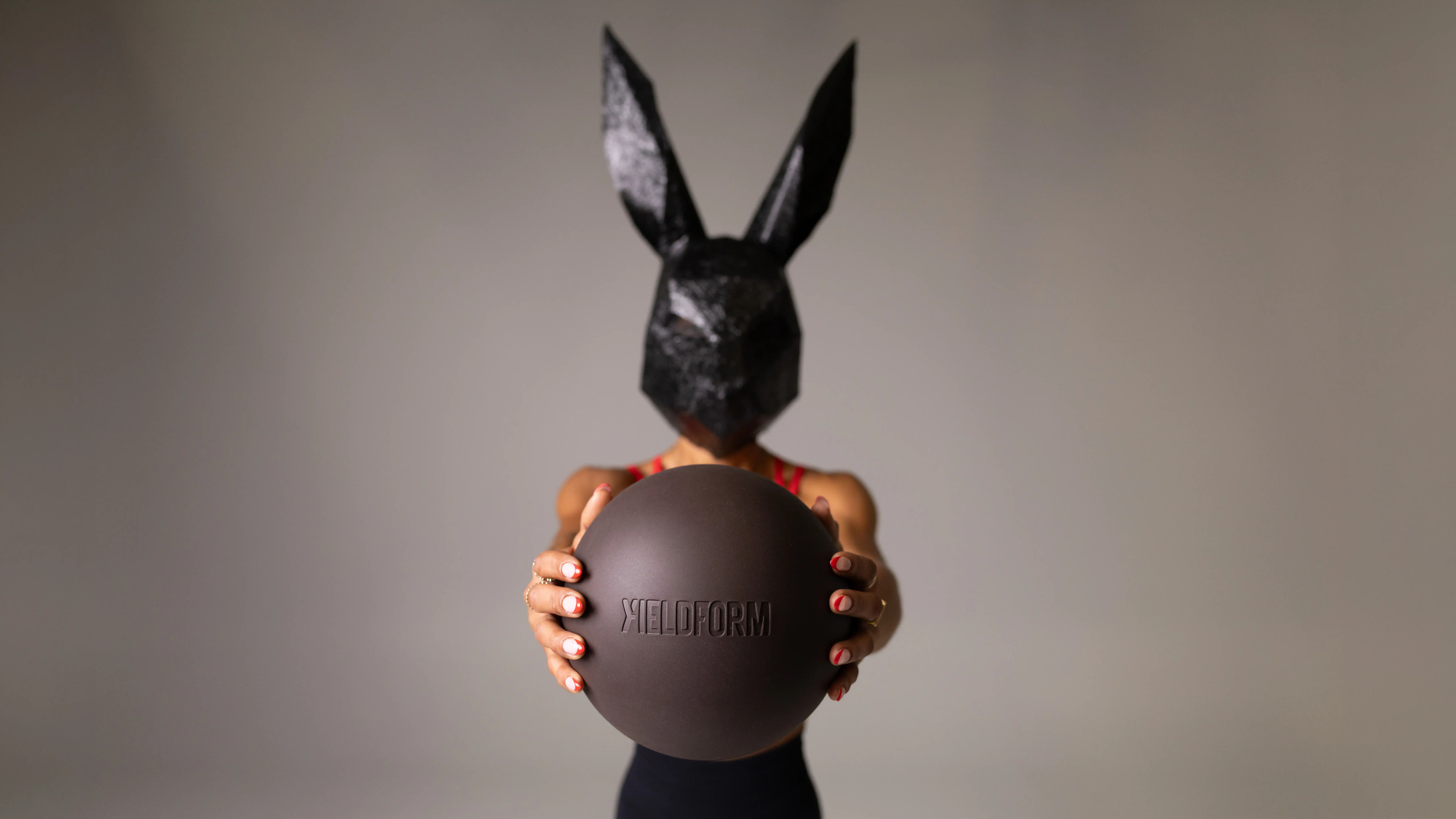 An agricultural drone with a rabbit mask holding a black ball, demonstrating advanced farming techno.